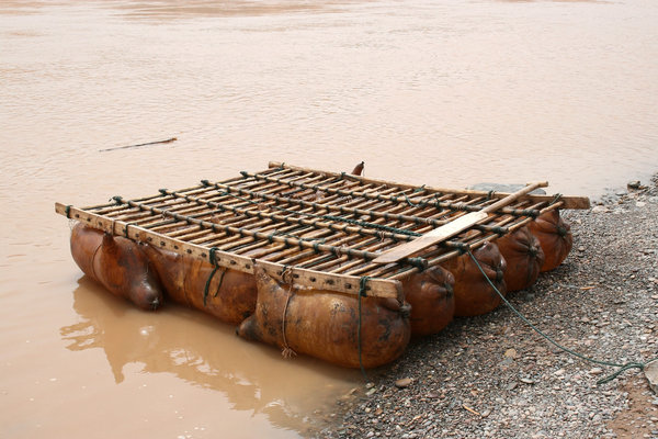 Raft: A raft made of inflated sheep skins lashed to a wooden framework 