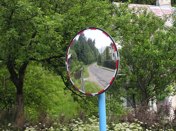Road mirror: A road sign - mirror. It helps drivers to see what is behind the corner.Please comment this shot or mail me if you found it useful. Just to let me know!I would be extremely happy to see the final work even if you think it is nothing special! For me it is 