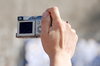 Compact photo camera in action