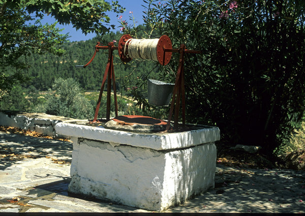 Well: An old public well with iron bucket at the yard of village church
