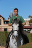 man riding white horse