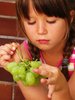 girl eating grapes