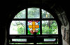 through the glass, dimly