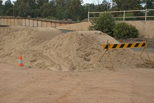 nature: a pile of sand with warning equipment 